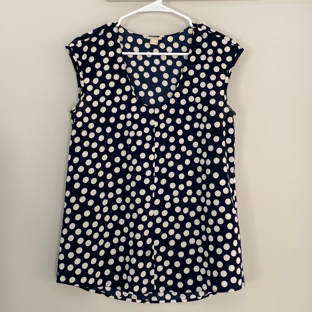 J Crew navy and white polka dot sleeveless blouse.